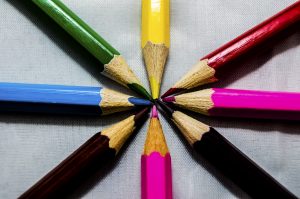 The tips of eight colored pencils all touching at a common center