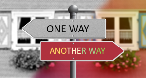 "One way" sign pointing to the left above "another way" sign pointing to the right