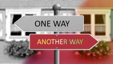 "One way" sign pointing to the left above "another way" sign pointing to the right