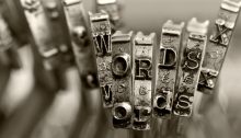 Typebars on an old typewriter that spell "words" in both uppercase and lowercase.