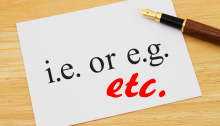 Pen on paper reading "i.e. or e.g." with "etc." drawn in red below.